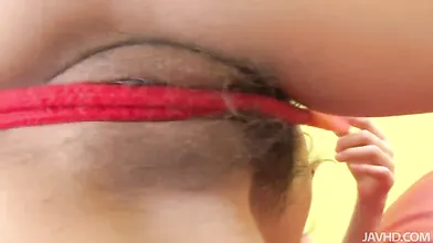 Suzuka plays with her sweet pussy with a red nylon rope as she moans and groans
