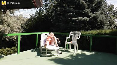 Naughty mature slut masturbating in the warm sun