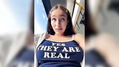 Playful Brunette Teasing with 'Yes They Are Real' Top on Public Transit & Outdoors