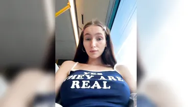 Brunette Woman Shows Natural Assets in Train Car - Yes They Are Real