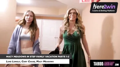 Smiling platinum-blonde honey with glasses in green dress